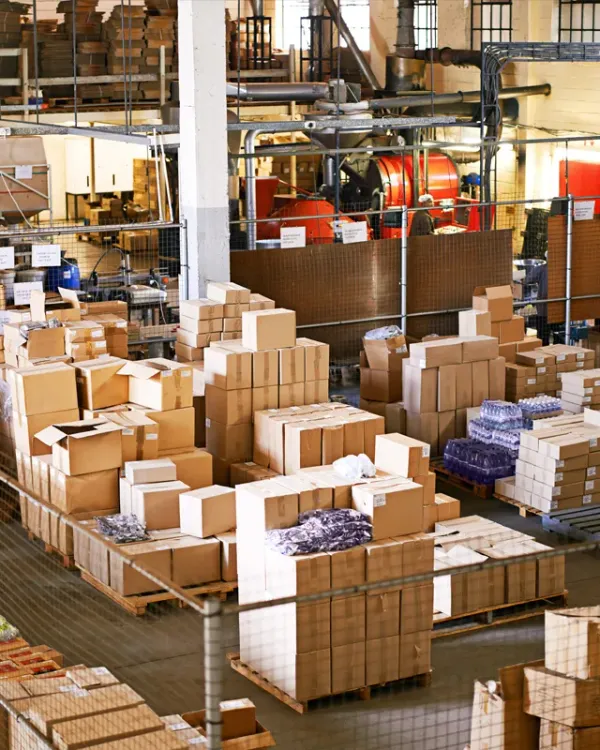 Warehouse floor stacked with boxed goods and process equipment